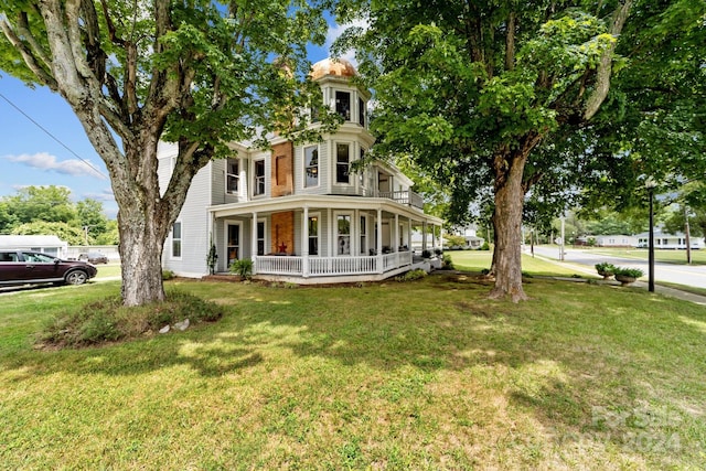 view of front of home with a porch and a front yard