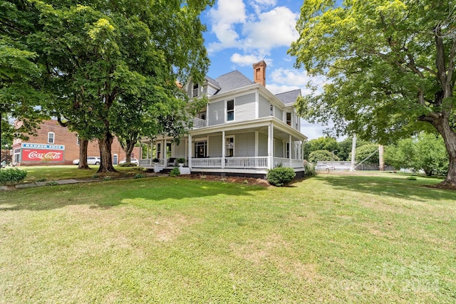 view of front of house with a front yard and covered porch