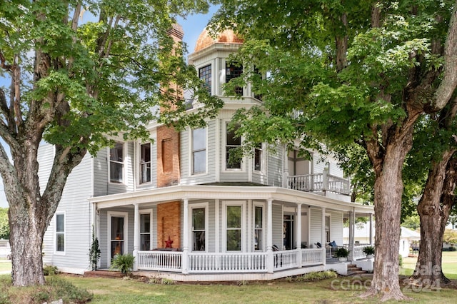 italianate home with a front lawn and covered porch