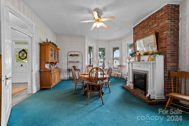 dining area featuring dark colored carpet, ceiling fan, and a textured ceiling