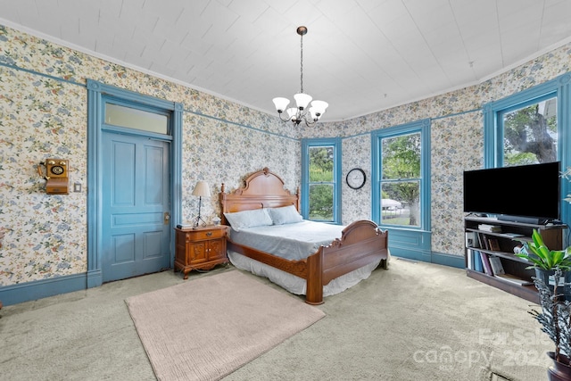 bedroom featuring light carpet, crown molding, and a chandelier