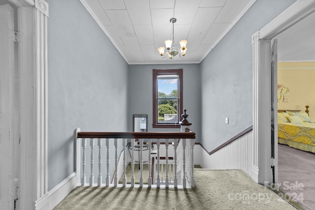 interior space featuring ornamental molding, carpet flooring, and a notable chandelier