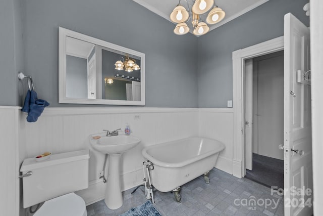 bathroom featuring toilet, tile patterned floors, a chandelier, and a tub to relax in