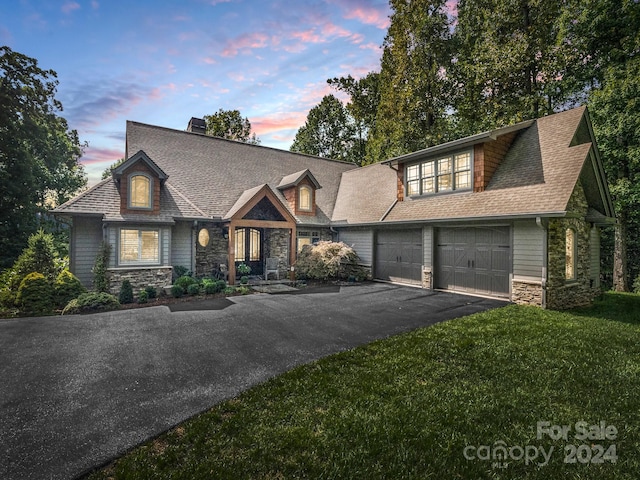 view of front of home featuring a garage and a lawn