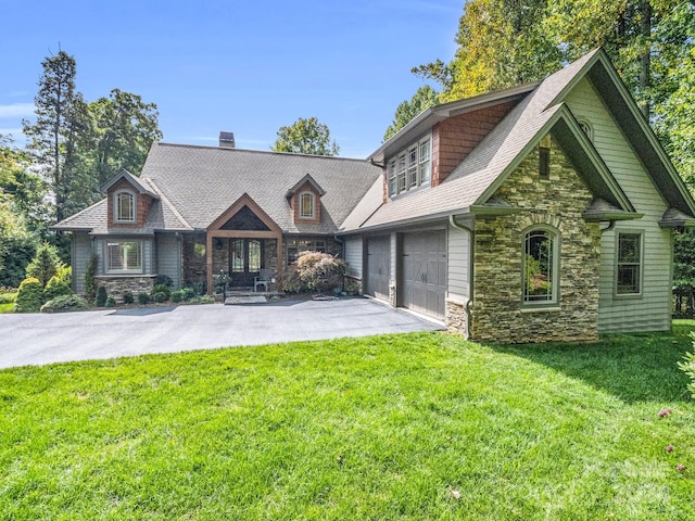 view of front of home featuring a garage and a front yard