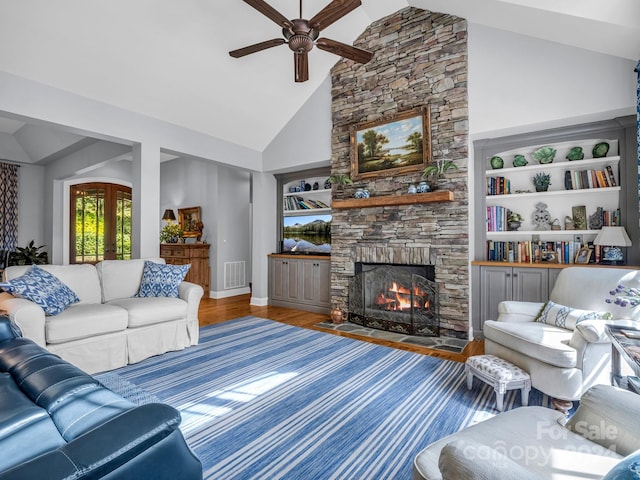 living room featuring a fireplace, high vaulted ceiling, hardwood / wood-style floors, and ceiling fan