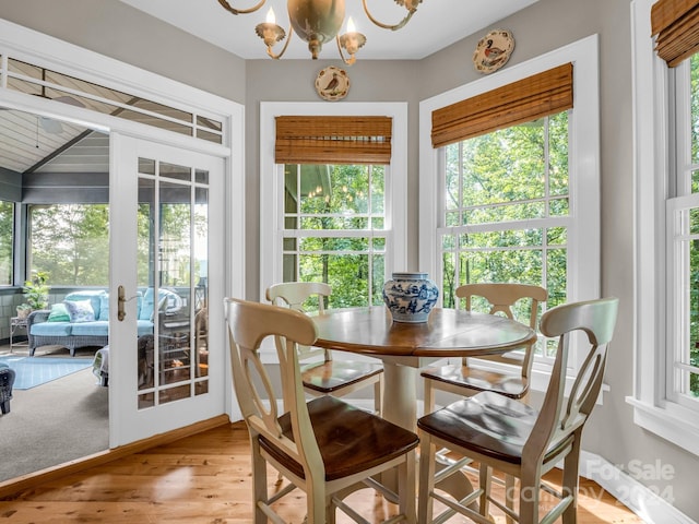 dining room featuring light wood-type flooring and a chandelier