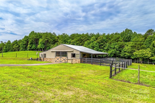 view of horse barn featuring a rural view