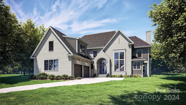 view of front of home featuring a front lawn and a garage