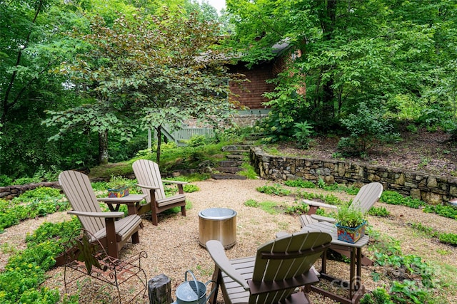 view of yard with stairway and an outdoor fire pit