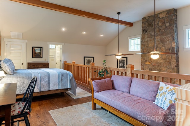 bedroom with vaulted ceiling with beams, wood finished floors, and visible vents