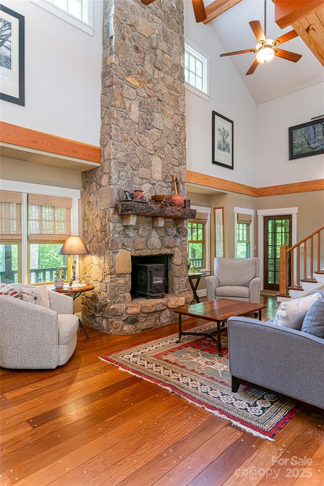 living area with a healthy amount of sunlight, ceiling fan, and wood-type flooring