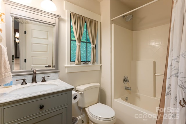 full bath featuring shower / bathtub combination with curtain, toilet, and vanity