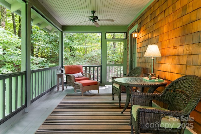 sunroom featuring ceiling fan