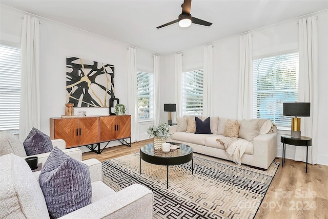 living room featuring a wealth of natural light, hardwood / wood-style flooring, and ceiling fan