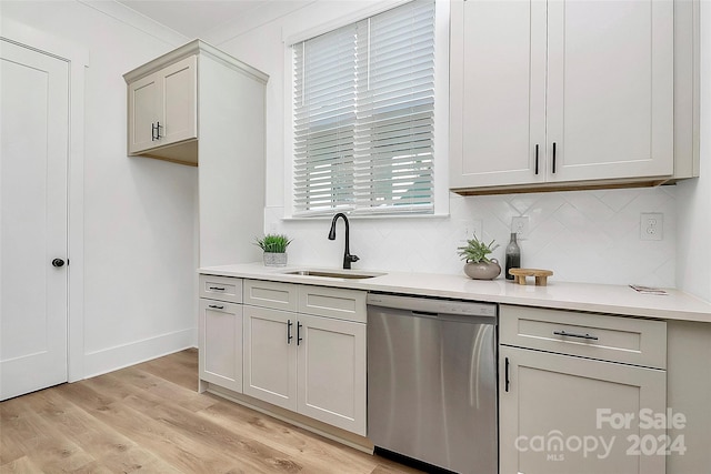 kitchen featuring dishwasher, decorative backsplash, sink, gray cabinets, and light hardwood / wood-style flooring