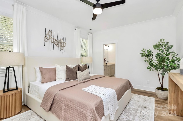 bedroom featuring ornamental molding, hardwood / wood-style flooring, ceiling fan, and connected bathroom