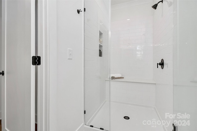 bathroom with a shower with shower door