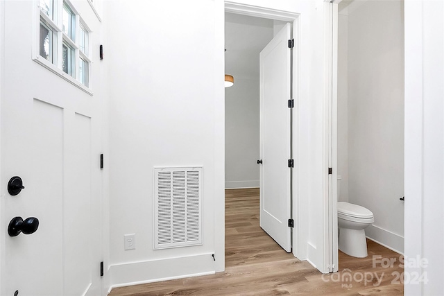 bathroom with wood-type flooring and toilet