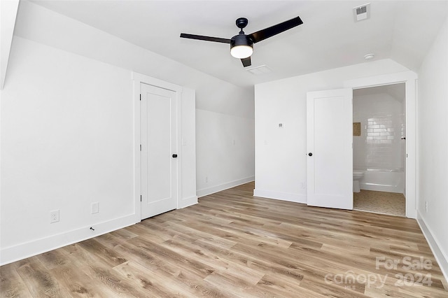 unfurnished bedroom with ceiling fan, light hardwood / wood-style floors, and ensuite bathroom