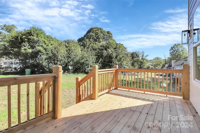 wooden deck with a lawn