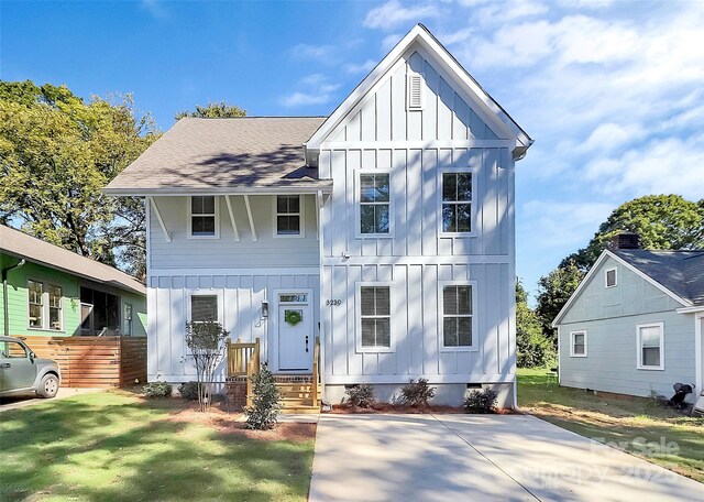3230 Rogers St, Charlotte, NC 28208 - view of front facade featuring roof with shingles, board and batten siding, crawl space, and a front yard