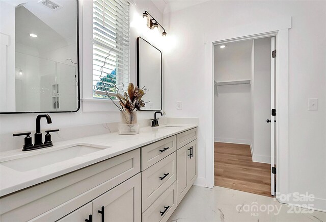 3230 Rogers St, Charlotte, NC 28208 - bathroom with double vanity, a sink, a shower stall, and visible vents