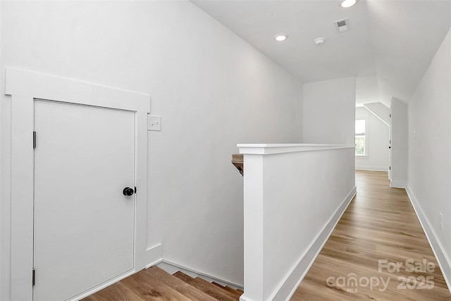 3230 Rogers St, Charlotte, NC 28208 - corridor featuring an upstairs landing, light wood-style flooring, visible vents, baseboards, and vaulted ceiling