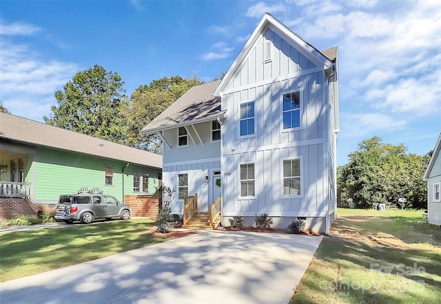 3230 Rogers St, Charlotte, NC 28208 - view of front facade with a front yard, roof with shingles, board and batten siding, entry steps, and crawl space