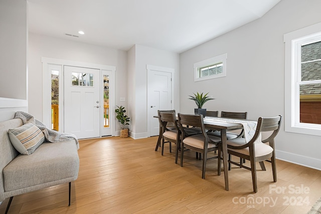 dining space with light hardwood / wood-style flooring