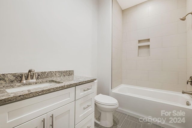 full bathroom featuring tiled shower / bath combo, toilet, tile patterned floors, and vanity