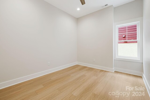 spare room with ceiling fan and light hardwood / wood-style flooring