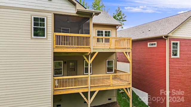 rear view of house featuring a sunroom and a balcony