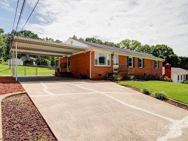 single story home featuring brick siding, a front yard, crawl space, a carport, and driveway