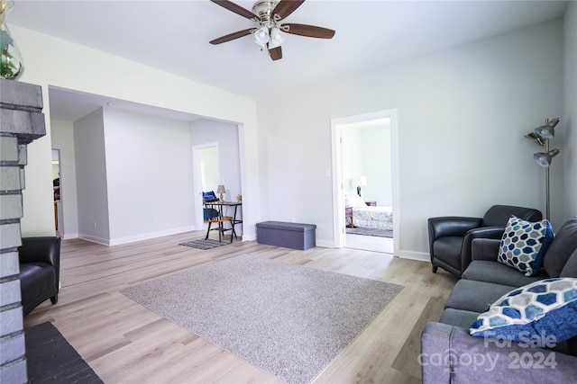 living room featuring light hardwood / wood-style flooring and ceiling fan