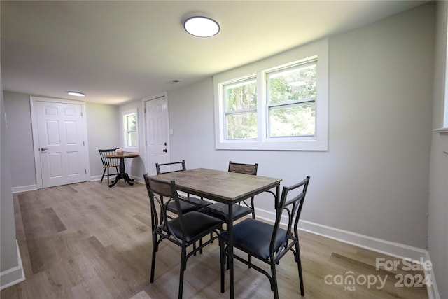 dining space with light hardwood / wood-style flooring