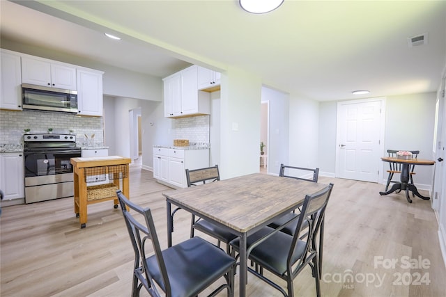 dining area with light hardwood / wood-style floors