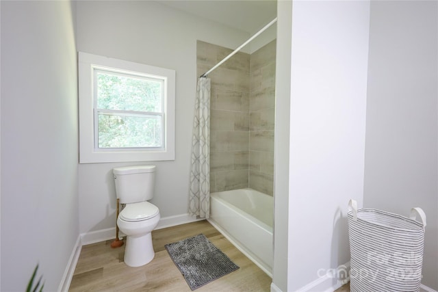 bathroom featuring shower / tub combo with curtain, toilet, and hardwood / wood-style floors