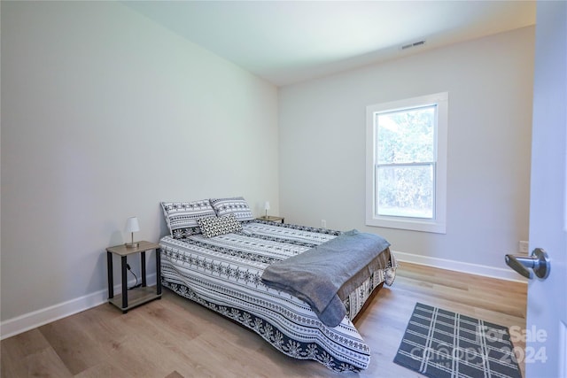 bedroom with hardwood / wood-style flooring