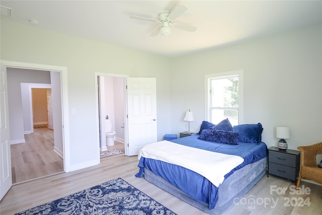 bedroom with light hardwood / wood-style flooring, ceiling fan, and ensuite bathroom