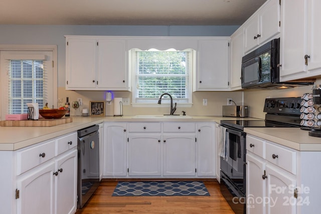 kitchen featuring white cabinetry, hardwood / wood-style flooring, sink, and black appliances