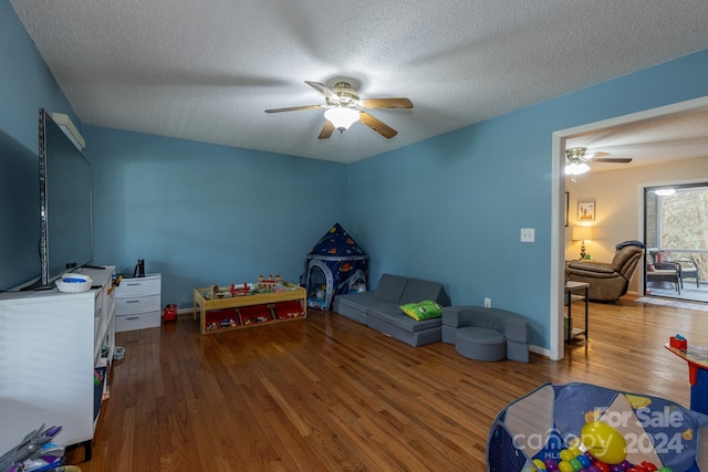 bedroom featuring hardwood / wood-style flooring, a textured ceiling, and ceiling fan