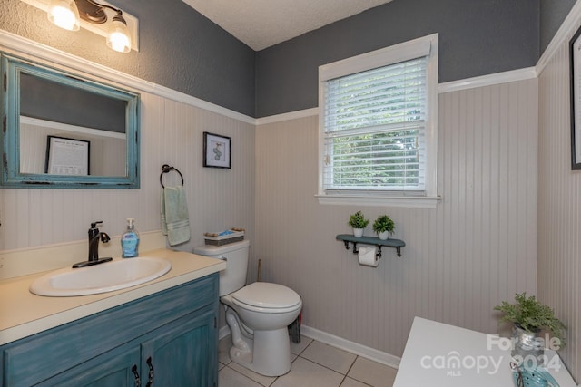 bathroom with vanity, toilet, and tile patterned flooring