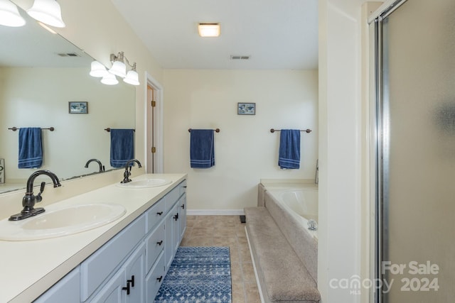 bathroom with tile patterned flooring, vanity, and separate shower and tub