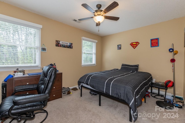 bedroom with light carpet and ceiling fan