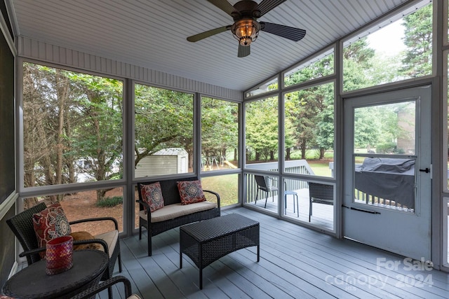 sunroom with ceiling fan, lofted ceiling, and a wealth of natural light