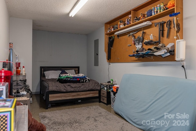 bedroom featuring electric panel and a textured ceiling