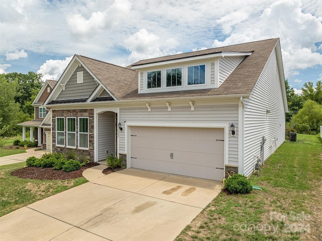 craftsman-style house with a garage, a front yard, and central air condition unit