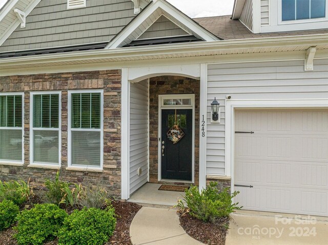 view of exterior entry featuring a garage