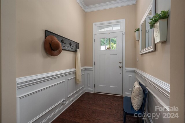 doorway with crown molding and dark hardwood / wood-style flooring